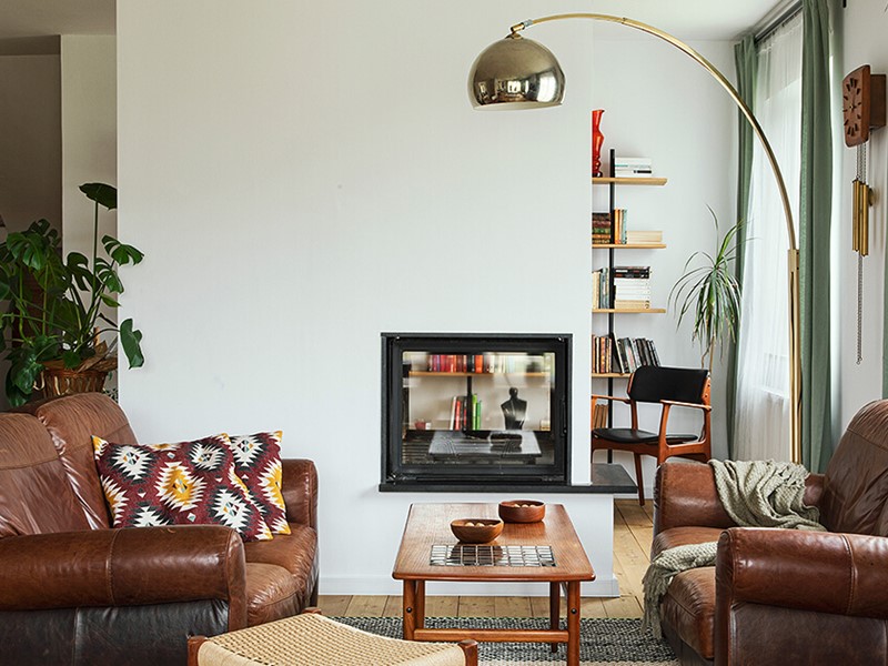 Small lounge room with lamp and brown furniture